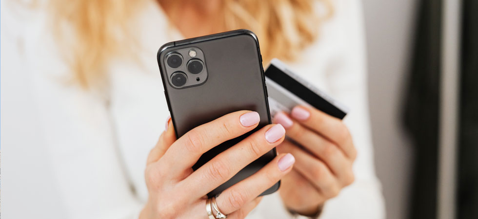 Woman paying on phone with credit card