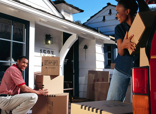 Couple packing boxes into vehicle